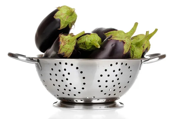 Fresh eggplants in colander isolated on white — Stock Photo, Image