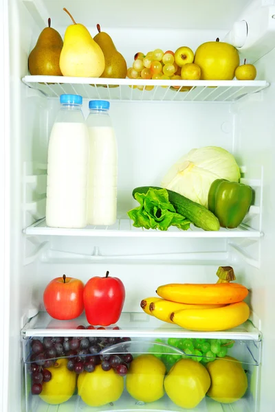 Milk, vegetables and fruits in refrigerator — Stock Photo, Image