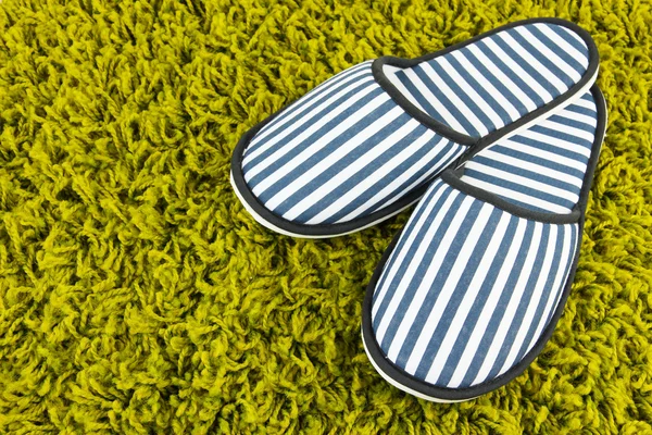 Striped slippers on carpet background — Stock Photo, Image