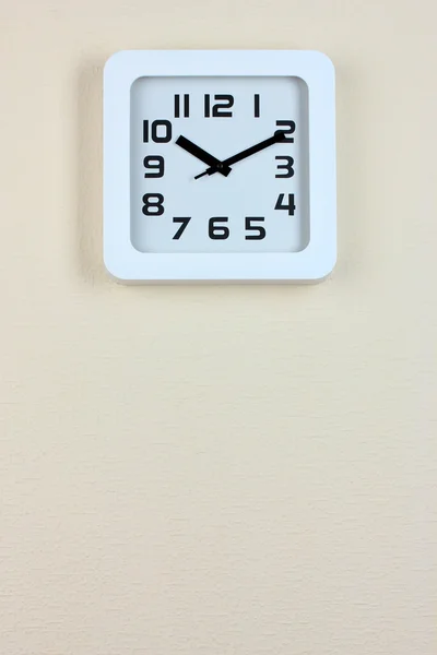 Office clock on color wall background — Stock Photo, Image