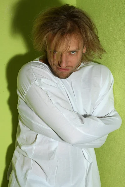 Mentally ill man in strait-jacket in room corner — Stock Photo, Image