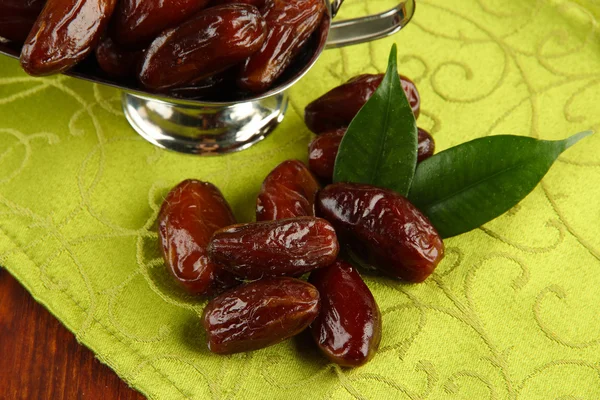 Dried dates in metal dish on fabric background — Stock Photo, Image