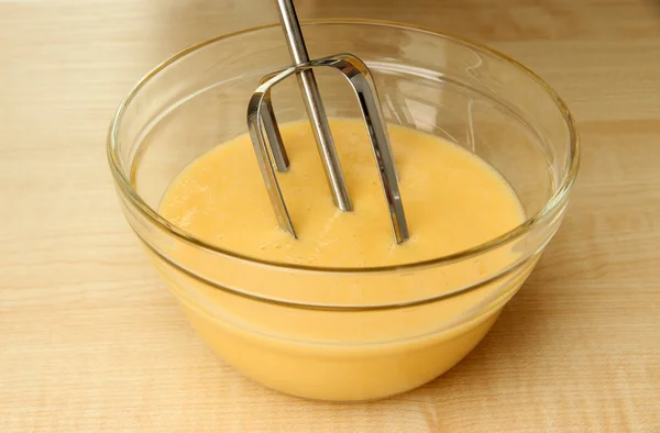 Cooking, whipping eggs with electric whisk in bowl, close up — Stock Photo, Image