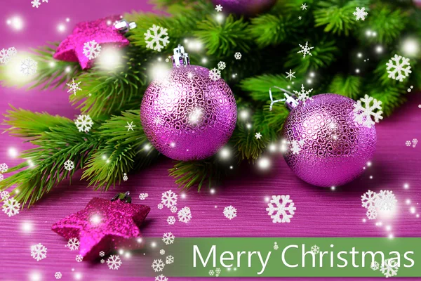 Christmas balls on fir tree, on color background — Stock Photo, Image