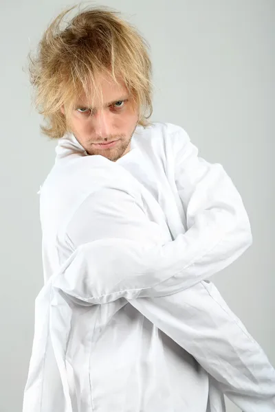 Mentally ill man in strait-jacket on gray background — Stock Photo, Image