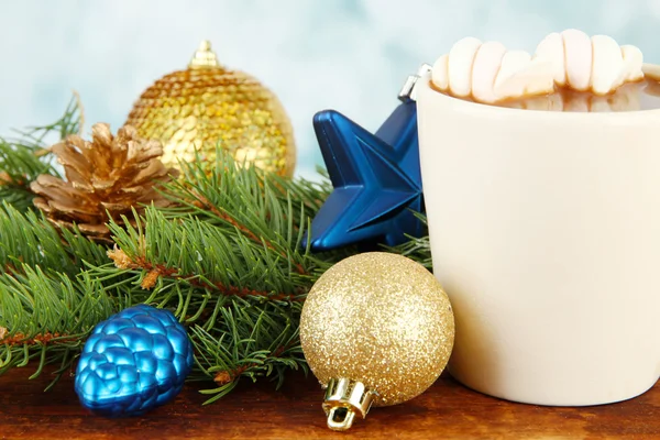 Cup of hot cacao with Christmas decorations on table on bright background — Stock Photo, Image