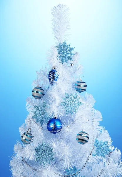 White Christmas tree on blue background — Stock Photo, Image