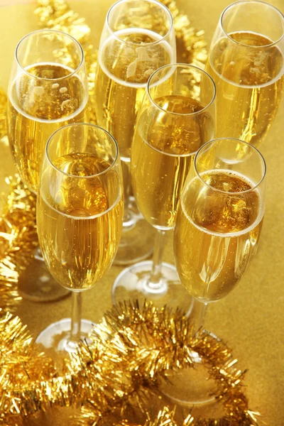 Glasses with champagne on shiny background — Stock Photo, Image