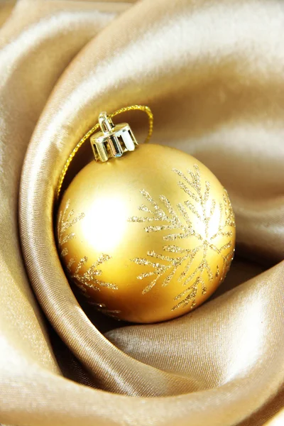 Piękny piłka Boże Narodzenie na złote tkaniny satynowe — Zdjęcie stockowe
