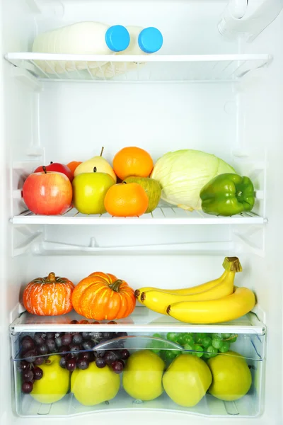 Milk bottles, vegetables and fruits in open refrigerator. Weight loss diet concept. — Stock Photo, Image