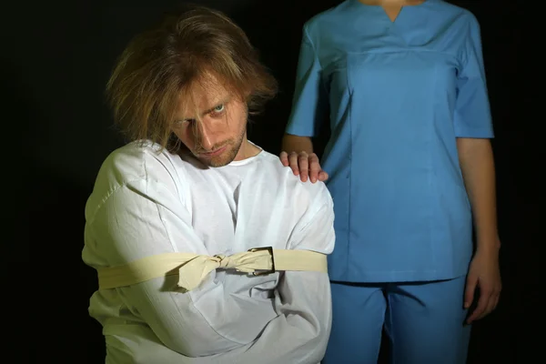 Mentally ill man in strait-jacket on black background — Stock Photo, Image