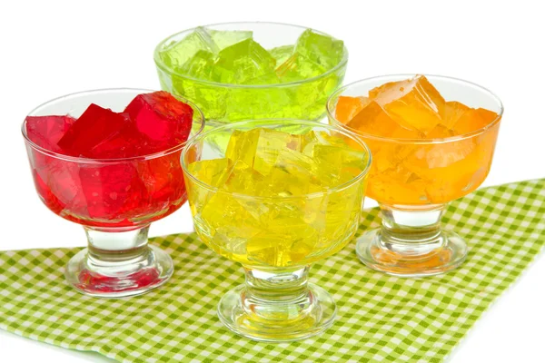 Sabrosos cubos de gelatina en cuencos en la mesa sobre fondo blanco —  Fotos de Stock