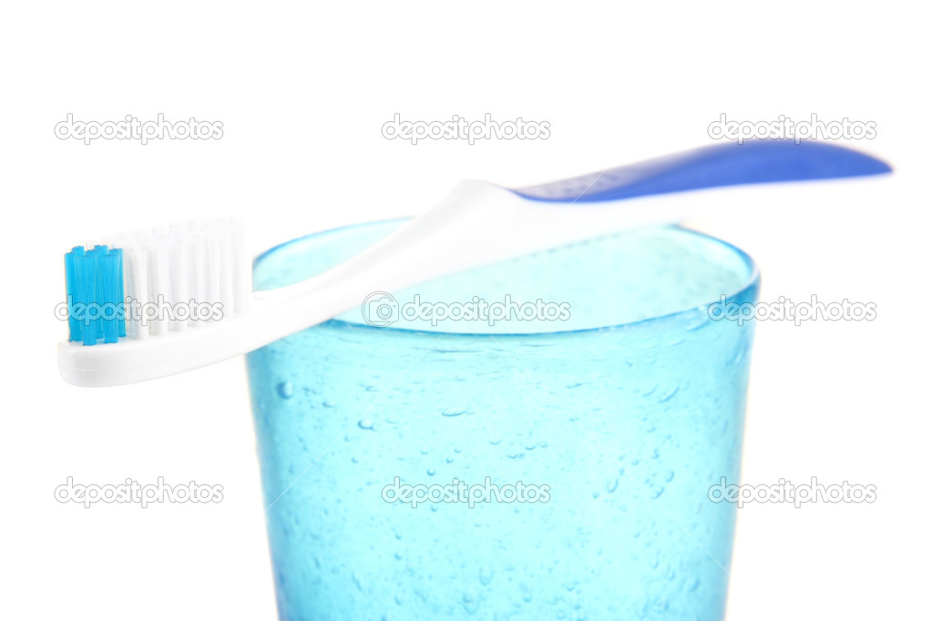 Tooth-brush on glass isolated on white