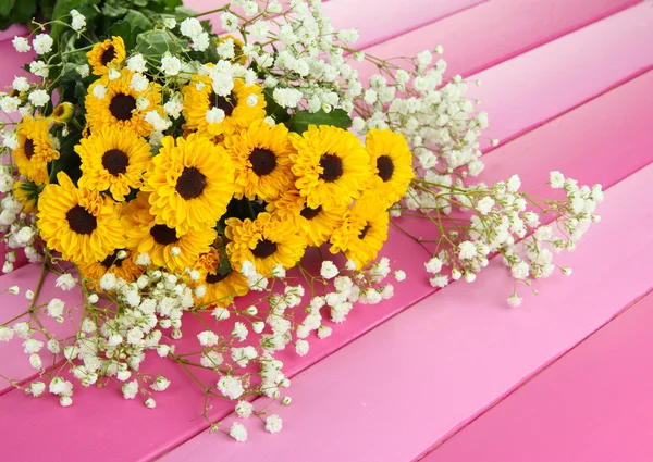 Beautiful flowers on wooden background — Stock Photo, Image
