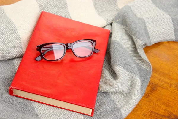 Composition with old book, eye glasses and plaid on wooden background — Stock Photo, Image