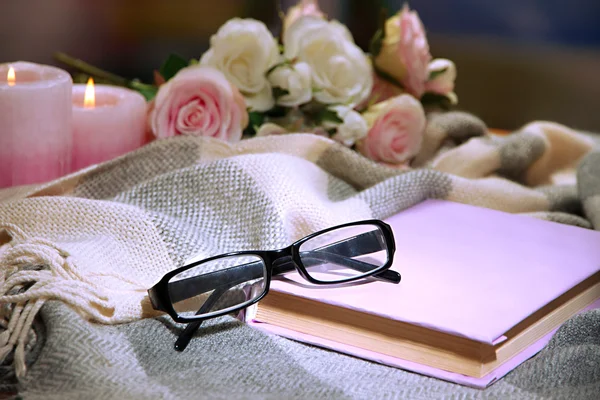 Composition with old book, eye glasses, candles and plaid on dark background — Stock Photo, Image