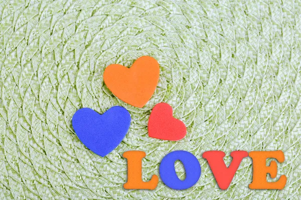 Hearts made of felt on green background — Stock Photo, Image