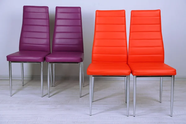 Modern color chairs on wall background — Stock Photo, Image