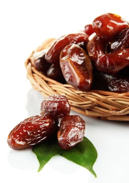 Dried dates on wicker plate isolated on white — Stock Photo, Image