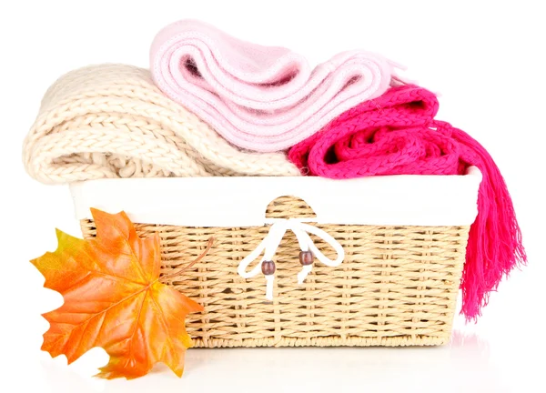 Warm knitted scarves in basket isolated on white — Stock Photo, Image