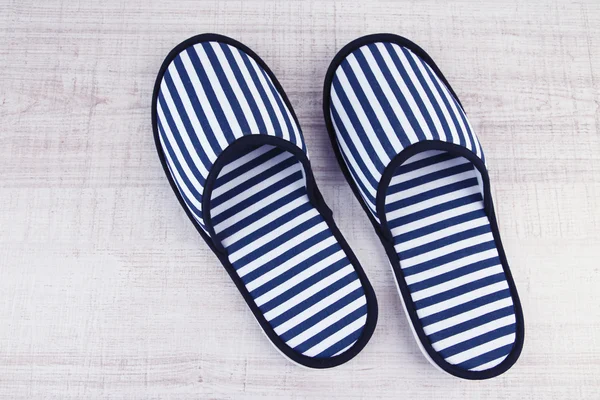 Striped slippers on wooden background — Stock Photo, Image