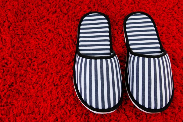 Striped slippers on carpet background — Stock Photo, Image