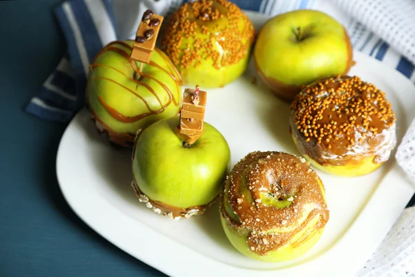 Homemade taffy apples, on napkin, on wooden background — Stock Photo, Image