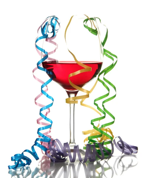 Glass of red wine and streamer after party isolated on white — Stock Photo, Image