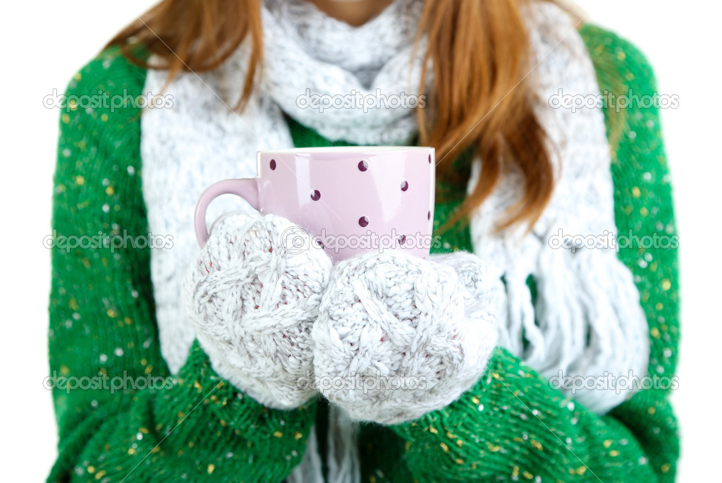 Womens hands in mittens with cup isolated on white