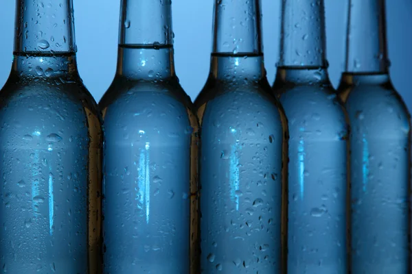 Water bottles on blue background — Stock Photo, Image