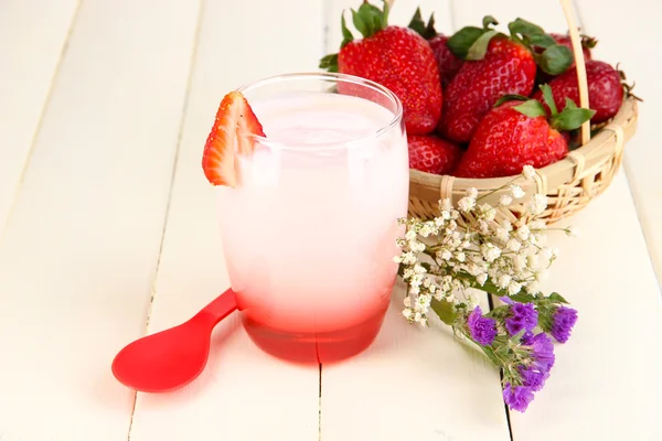 Delicious strawberry yogurt in glass on wooden table close-up — Stock Photo, Image