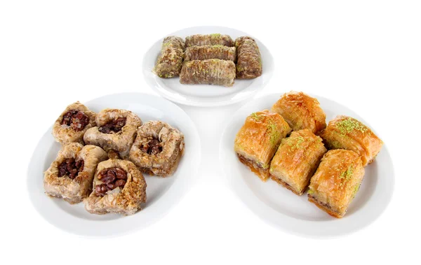 Sweet baklava on plates isolated on white — Stock Photo, Image