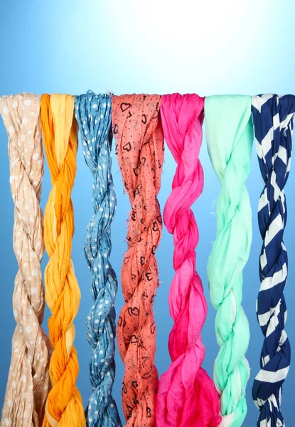 Colored scarves on blue background — Stock Photo, Image