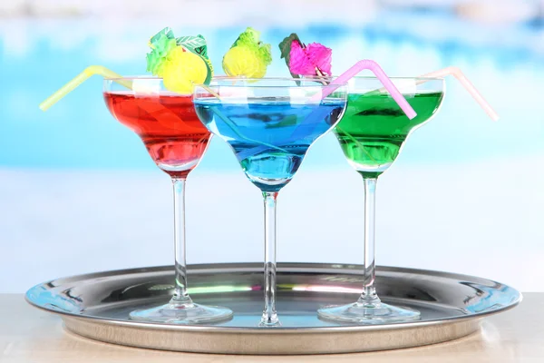 Different cocktails on bright background — Stock Photo, Image