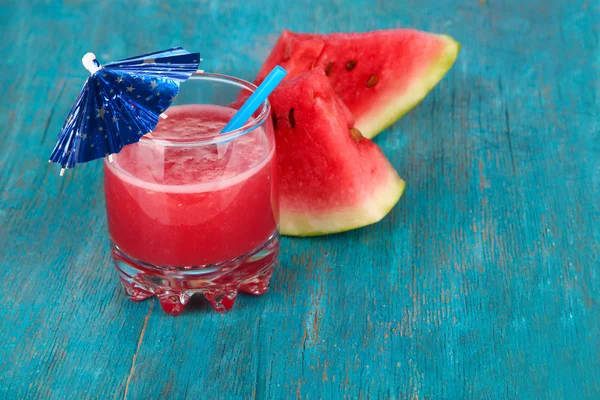 Glass of fresh watermelon juice, on wooden table, on wooden background — Stock Photo, Image