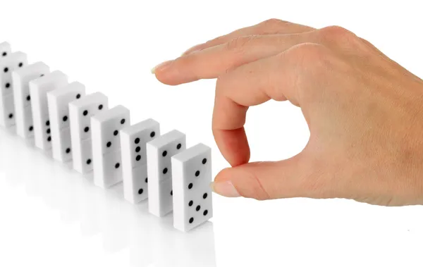 Mano spingendo domino isolato su bianco — Foto Stock