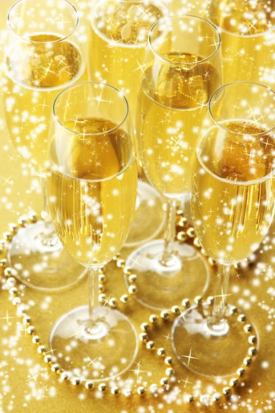 Glasses with champagne on shiny background — Stock Photo, Image