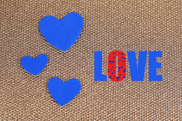 Blue hearts made of felt on golden background — Stock Photo, Image