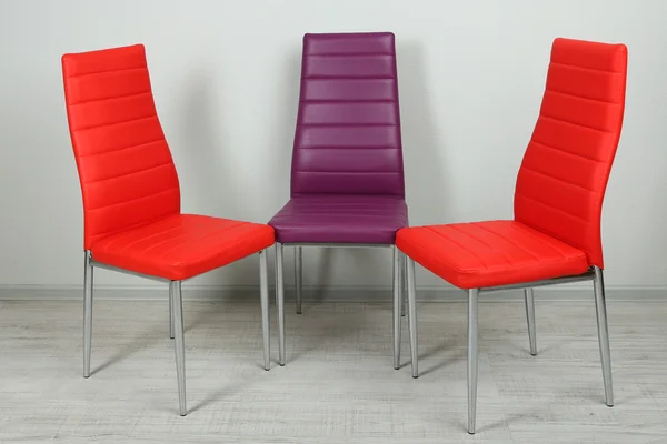 Modern color chairs on wall background — Stock Photo, Image