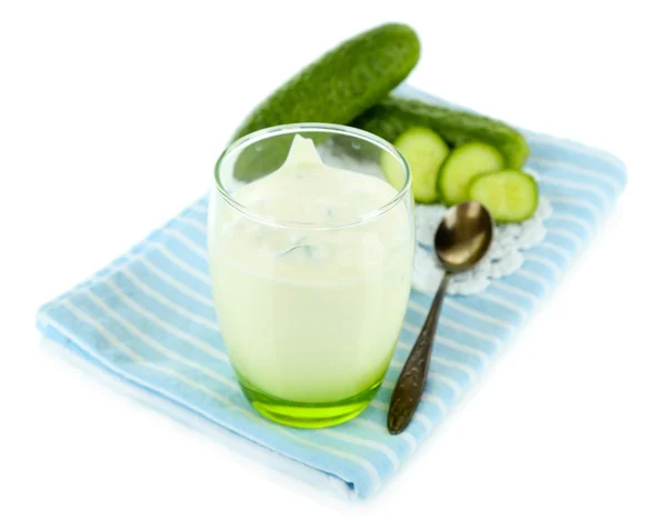 Cucumber yogurt in glass, on color napkin, isolated on white — Stock Photo, Image