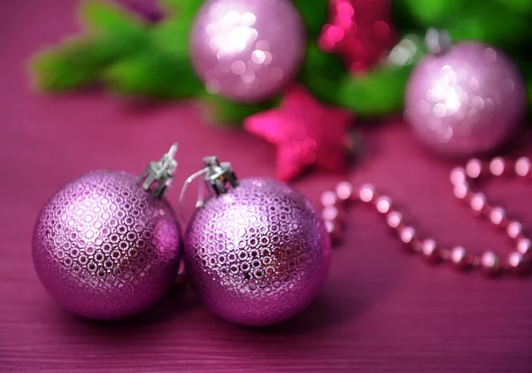 Christmas balls on fir tree, on color background — Stock Photo, Image