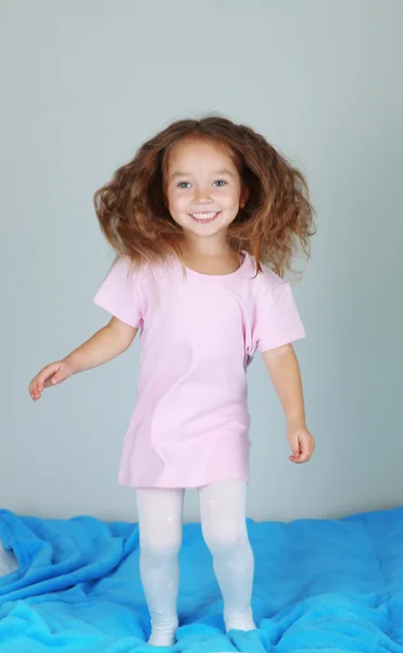 Little girl jumping on bed — Stock Photo, Image