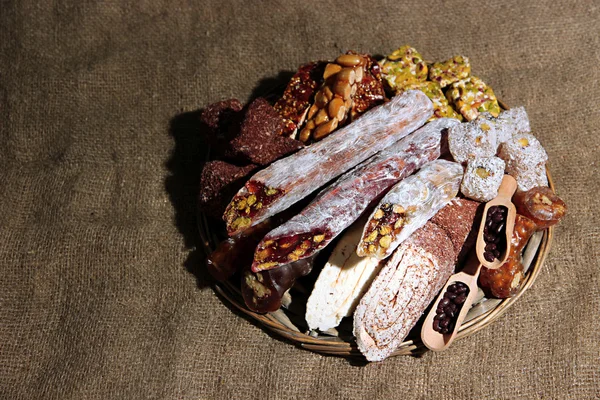 Tasty oriental sweets, on burlap background — Stock Photo, Image
