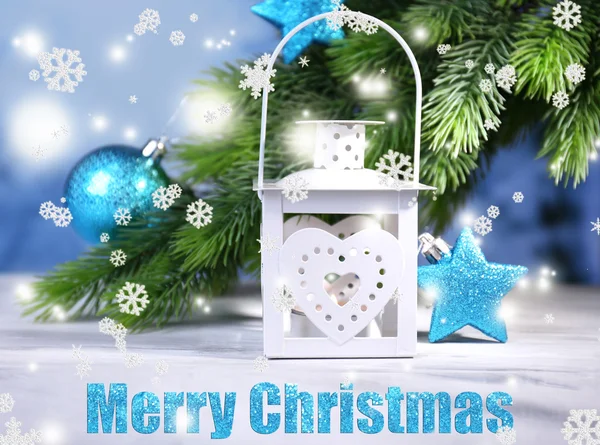 Christmas lantern, fir tree and decorations on light background