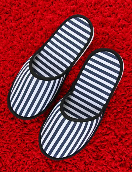 Striped slippers on carpet background — Stock Photo, Image