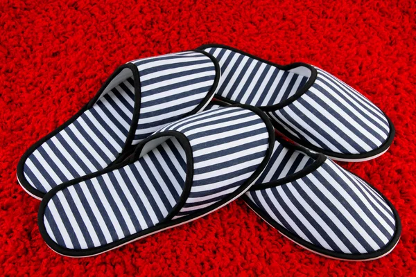 Striped slippers on carpet background — Stock Photo, Image