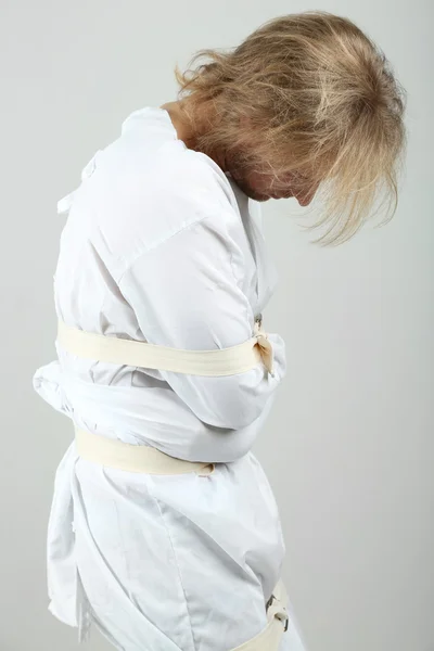 Boğazı-ceket gri arka plan üzerine Zihinsel hastalıklı bir adam — Zdjęcie stockowe