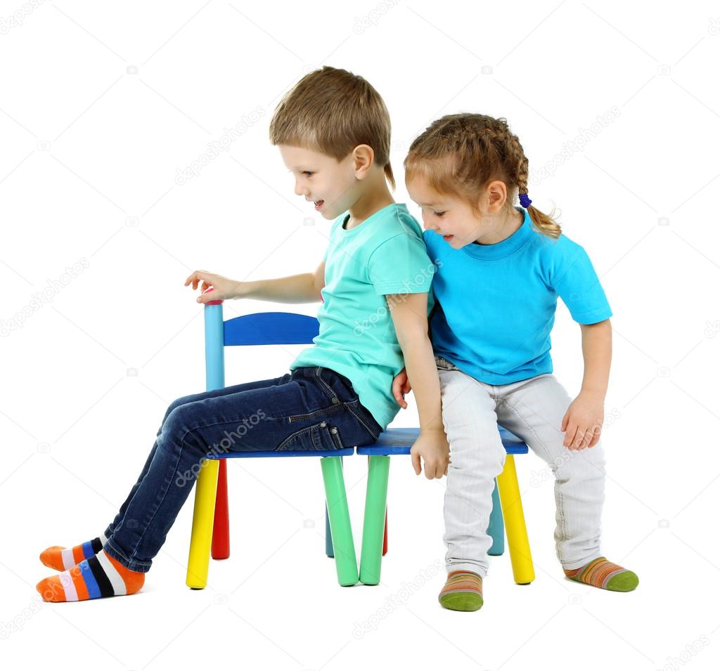 Little children playing on chairs isolated on white