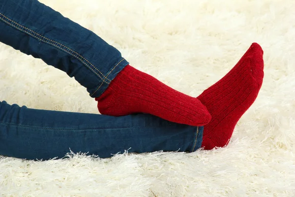 Female legs in colorful socks on white carpet background — Stock Photo, Image