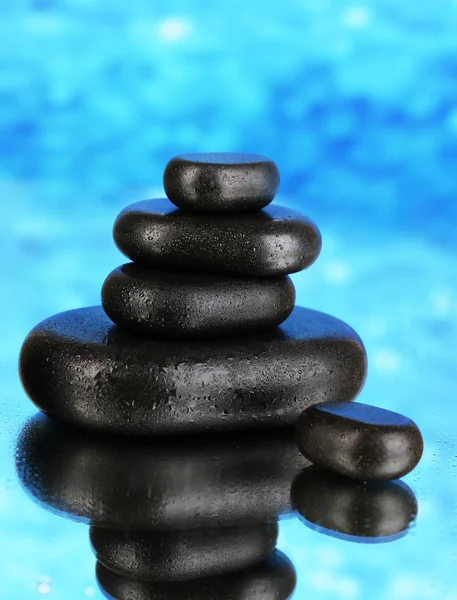 Spa stones on blue bright background — Stock Photo, Image